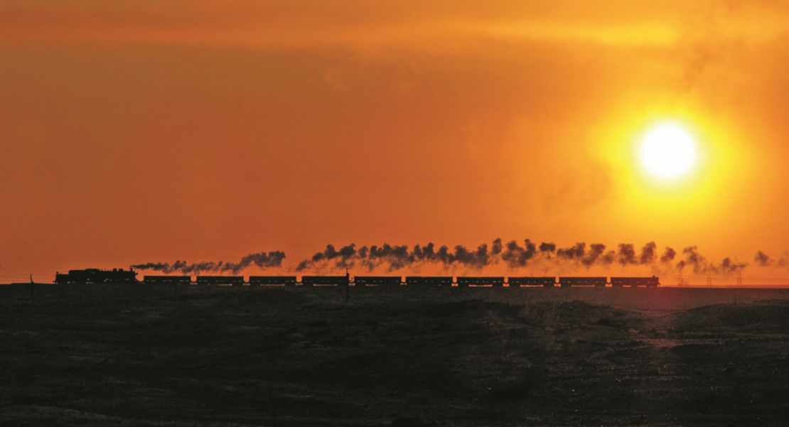 Kitching captured stunning shots -- including this 2006 photograph of a silhouetted locomotive at Jalainur coal mine at sunset.