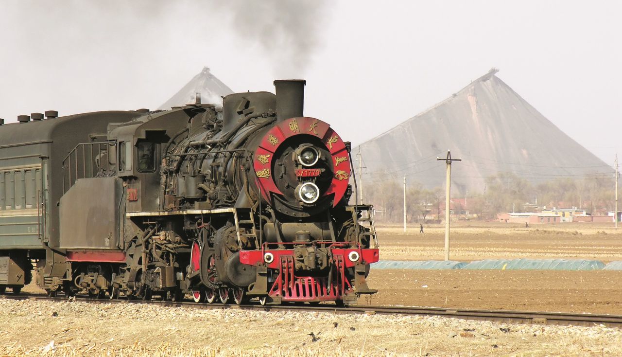 <strong>New opportunities:</strong> Kitching would love to photograph China's modern trains in the future. Pictured here: A passenger train departs Qiaonan Junction for Wangqian in 2005, on the southernmost branch of the system. 