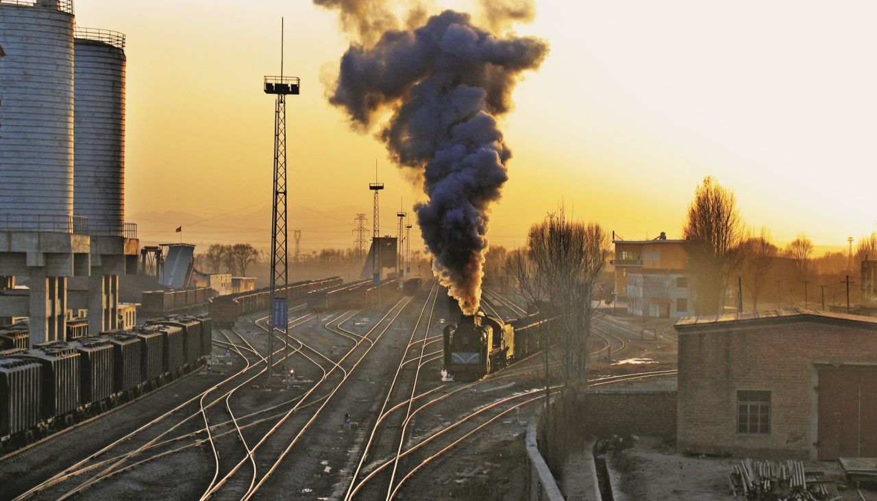<strong>New trains: </strong>Kitching has plans to return to China to document the new stage in Chinese railways:<strong> </strong>"I am already planning another trip to photograph trains in both China and also on the vast plains of the Mongolian Republic." Pictured here: The sun setting on steam operations at Xizhan -- both metaphorically and literally -- in 2006.