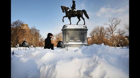 A pedestrian walks by a statue of George Washington in Boston's Public Garden on Friday, January 5, the morning after a massive storm. Blasts of arctic air have brought weather-related deaths, record low temperatures and historic amounts of snowfall to parts of the United States.