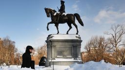 BOSTON, MA - JANUARY 05:  A man walks by the Washington statue in the Public Garden the morning after a massive winter storm on January 5, 2018 in Boston, Massachusetts. Schools and businesses throughout the Boston area get back to work today after the city received over a foot of snow during a fast moving storm yesterday.  (Photo by Spencer Platt/Getty Images)