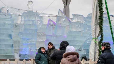 Visitors take pictures with an ice sculpture of Ronaldo in the background