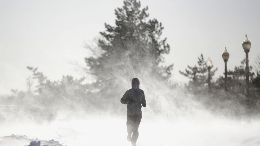 Gusty wind picks up snow accumulated on the ground as Jesse Sherwood, of Jersey City, N.J., jogs at Liberty State Park, Saturday, Jan. 6, 2018, in Jersey City. About 100 million people faced a new challenge after the whopping East Coast snowstorm: a gusty deep freeze, topped Saturday by a wind chill close to minus 100 on New Hampshire's Mount Washington that vied for world's coldest place.