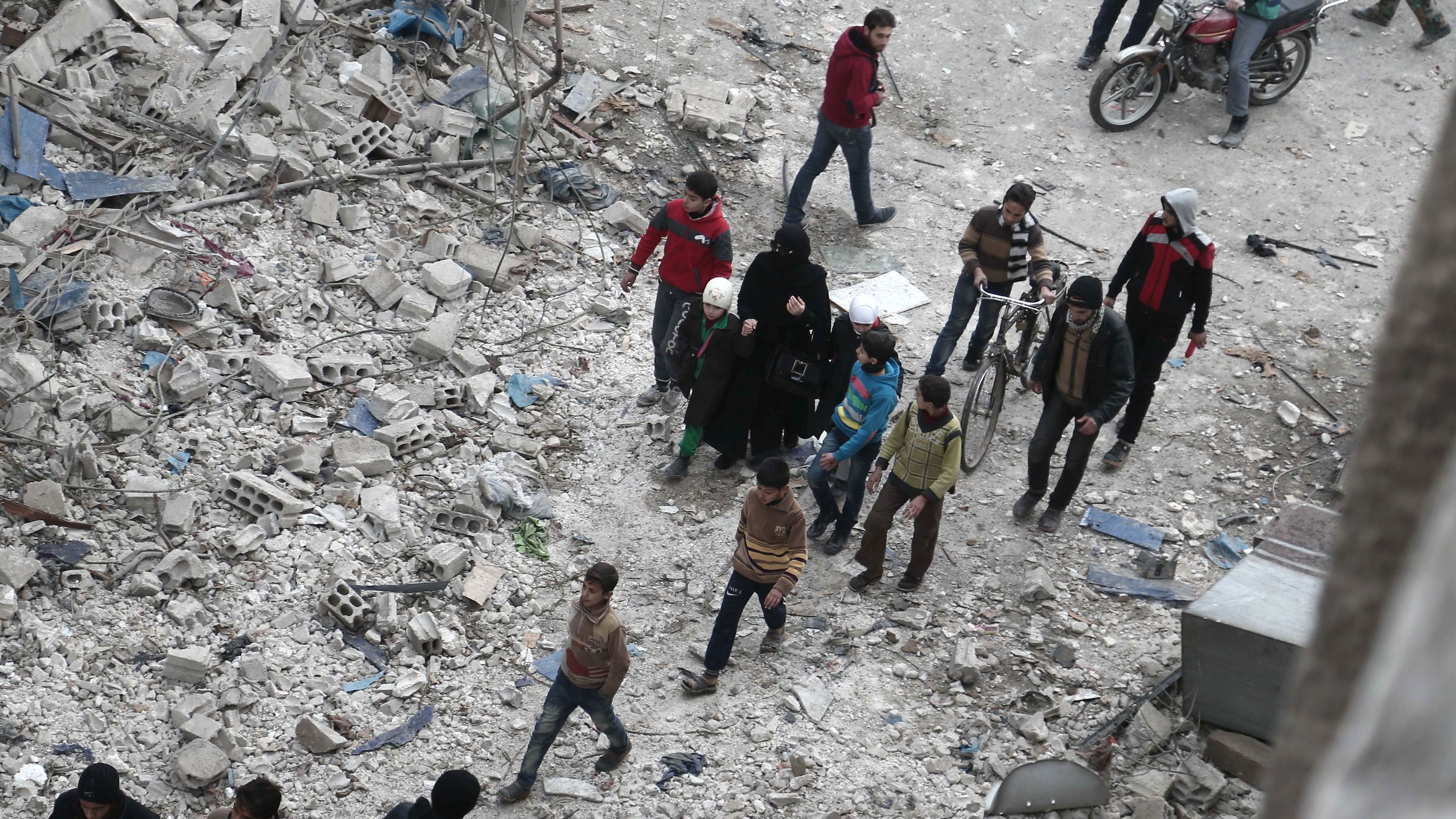 Syrian civilians inspect the damage following air raids on Eastern Ghouta, Syria, on Saturday. 