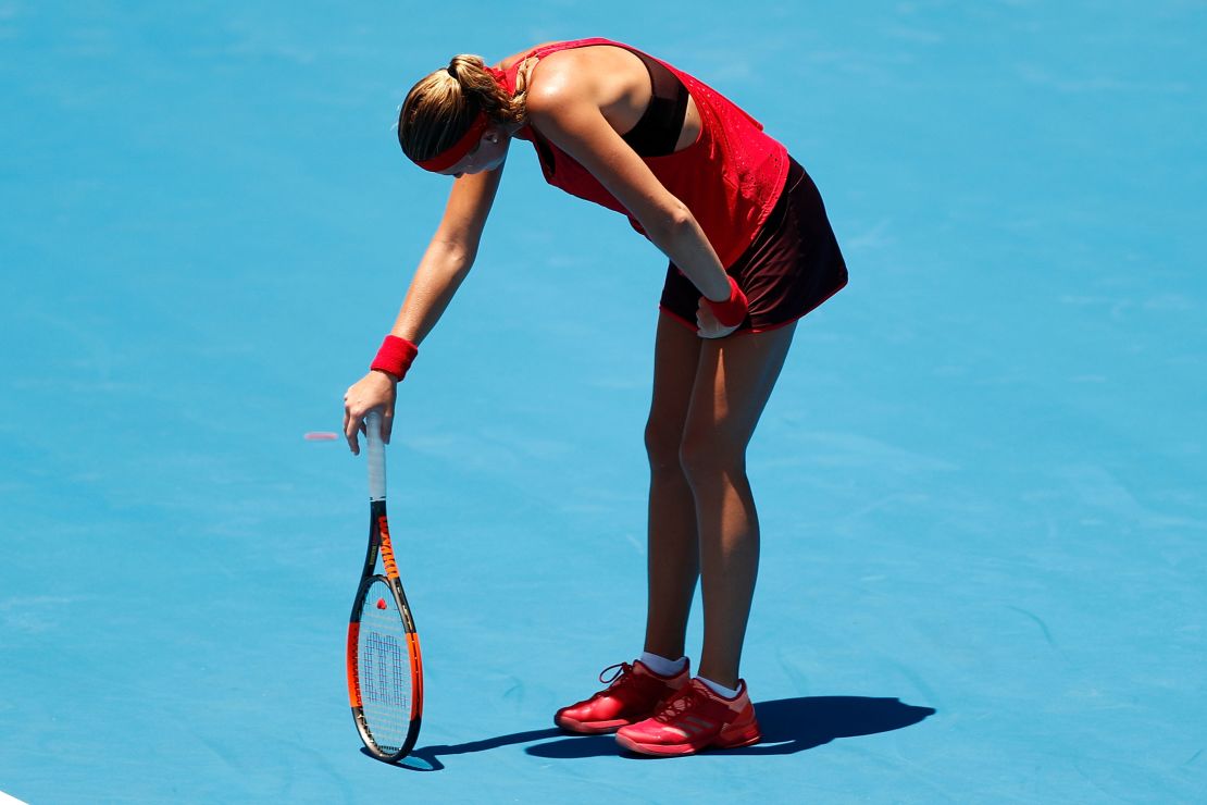 Kristina Mladenovic of France succumbs to the heat playing against Ellen Perez of Australia.