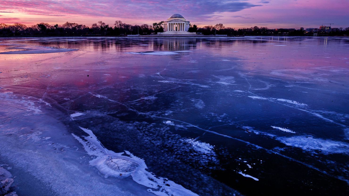 The Jefferson Memorial is reflected in the frozen surface of the Tidal Basin at daybreak in Washington on Monday.