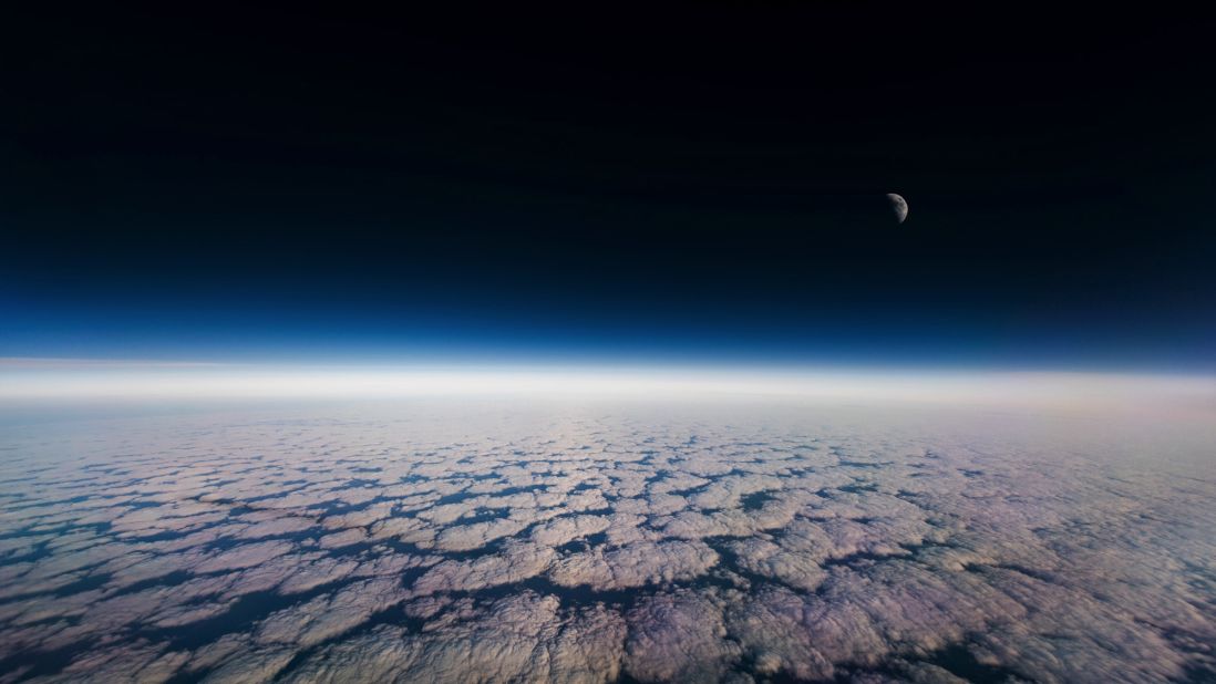 <strong>Inside the process</strong>: The images are usually long exposure shots. Van Heijst leaves his camera on the cockpit's glare shield and uses a wide angle lens to capture as much of the scene as possible. <em>Pictured here: The moon and clouds from the window.</em>