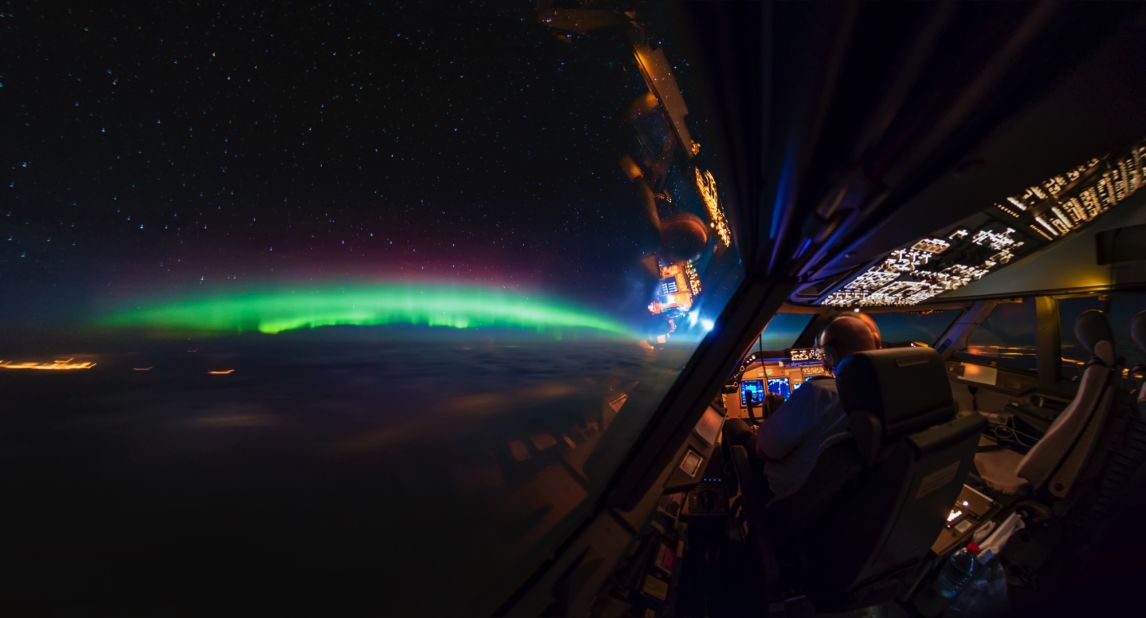 <strong>Aurora Borealis:</strong> The Northern Lights is one of van Heijst's favorite views he has captured: "The Aurora, that's just always beautiful no matter how often I see it, it's just always fantastic," he says. <em>Pictured here: Northern Lights over Canada and the cockpit.</em>