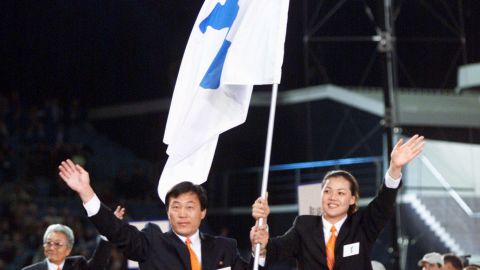 North Korea's Pak Jang Choo, left, and South Korea's Chung Eun-Soon carry a special flag showing the Korean peninsula as their teams march together at the 2000 Summer Olympics. 