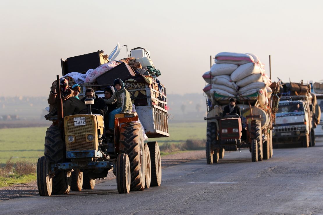 Syrians who fled Idlib province travel along a road in a rebel-held area near Saraqib on Sunday. 
