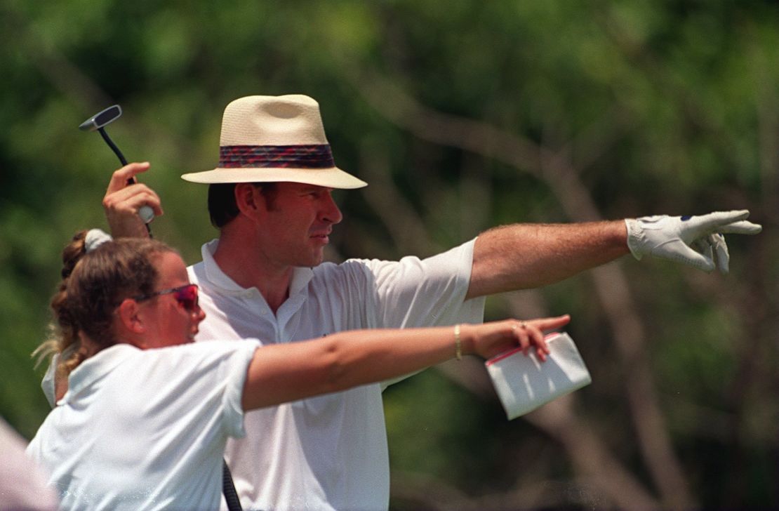 CADDIE FANNY SUNESSON POINTS THE WAY TO NICK FALDO
