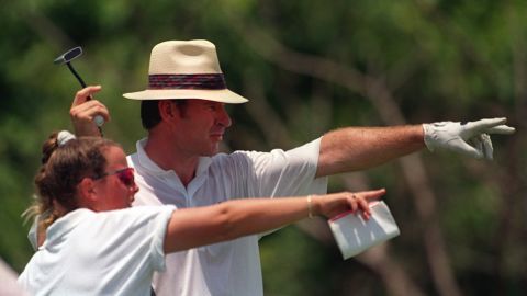 Sunesson points with Nick Faldo during a round.