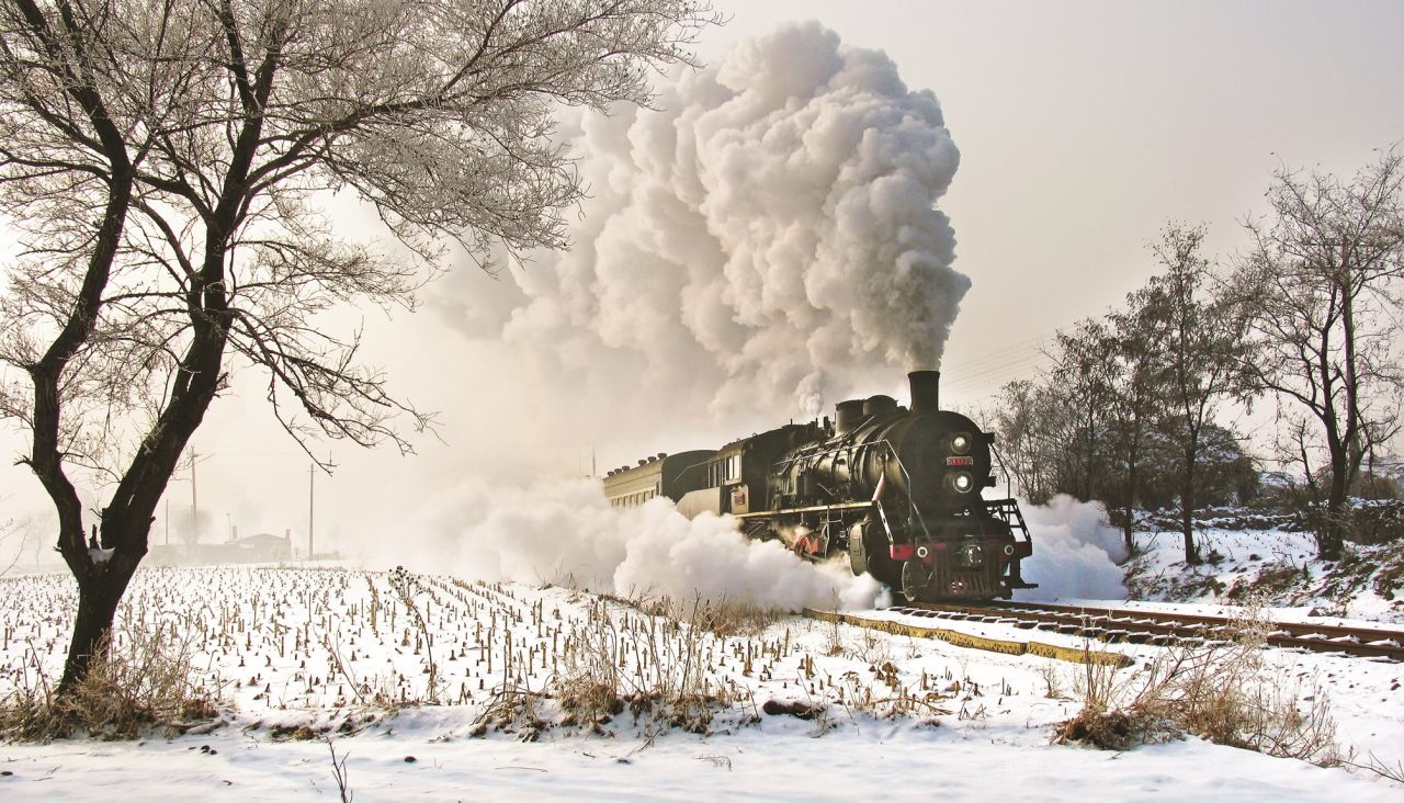 <strong>Winter extremes: </strong>Kitching normally traveled in winter to get the best photographs -- the exhaust from steam trains is at its most striking in cold conditions. The exhaust looks spectacular in this 2006 photo of the Tiefa Coal Rialway, the last standard-gauge steam locomotive built in China.
