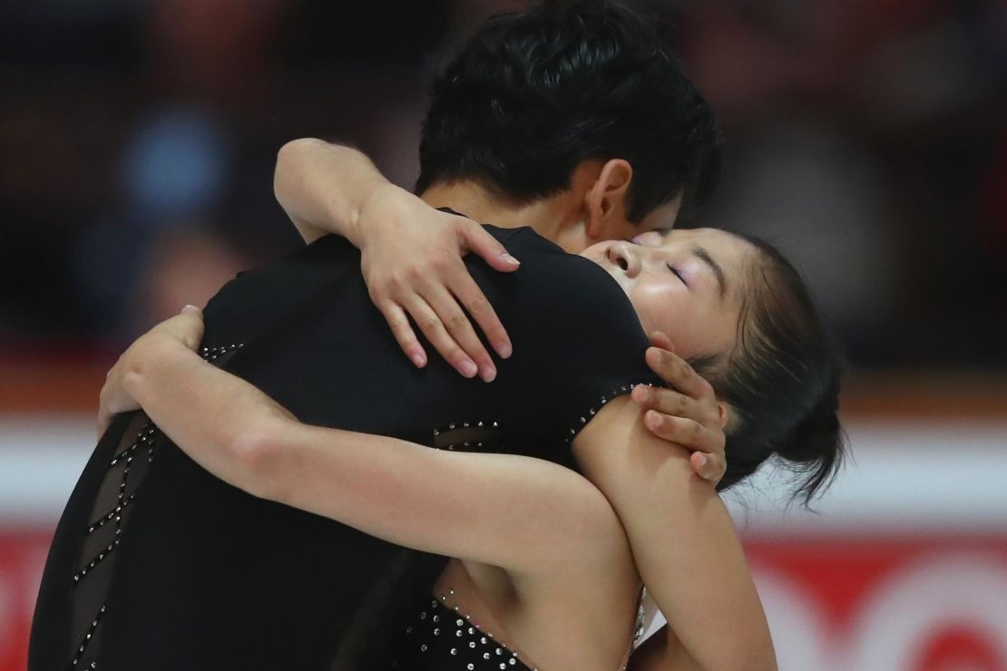 The two North Korean skaters embrace after performing at the pairs free skating during the Nebelhorn Trophy.