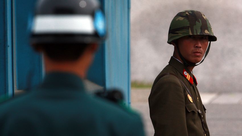 PANMUNJOM, SOUTH KOREA - SEPTEMBER 29:  (SOUTH KOREA OUT)  In this handout photo from Chosun Daily News, a North Korean Soldier (R) looks at South Korean soldier at the border village of Panmunjom between North and South Korea on September 29, 2010 in Panmunjom, South Korea. The two Koreas plan to hold military talks in Panmunjom in an attempt to ease tensions between the countries. The mooted talks come in the wake of speculation over the succession of leader Kim Jong-il by his son Kim Jongun. (Photo by Lee Tae-Kyung/Getty Images)