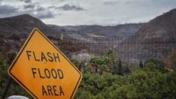 In this photo provided by Santa Barbara County Fire Department, a flash flood area sign is posted, as evacuations have been issued for several fire-ravaged communities in Santa Barbara, Calif., Monday, Jan. 8, 2018. Property owners stacked sandbags in devastated Northern California wine country Monday as authorities in Southern California ordered about 21,000 people to evacuate below hillsides burned by the state's largest wildfire in history. (Mike Eliason/Santa Barbara County Fire Department via AP)
