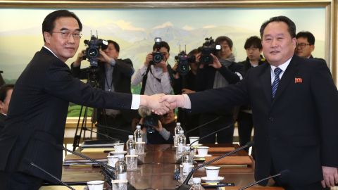 South Korean Unification Minister Cho Myoung-gyon (left) shakes hands with North Korea's chief delegate Ri Son-gwon prior to their meeting in the truce village of Panmunjom on January 9, 2018.