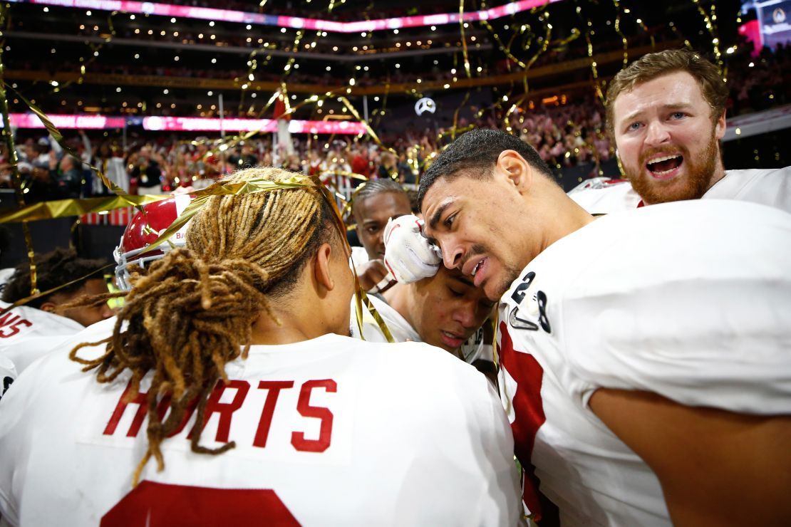 Alabama players hug after the victory. At center is Tua Tagovailoa, the freshman quarterback who came on at halftime and helped spark the team to a comeback victory. The Crimson Tide trailed 13-0 at halftime and 20-7 in the third quarter.