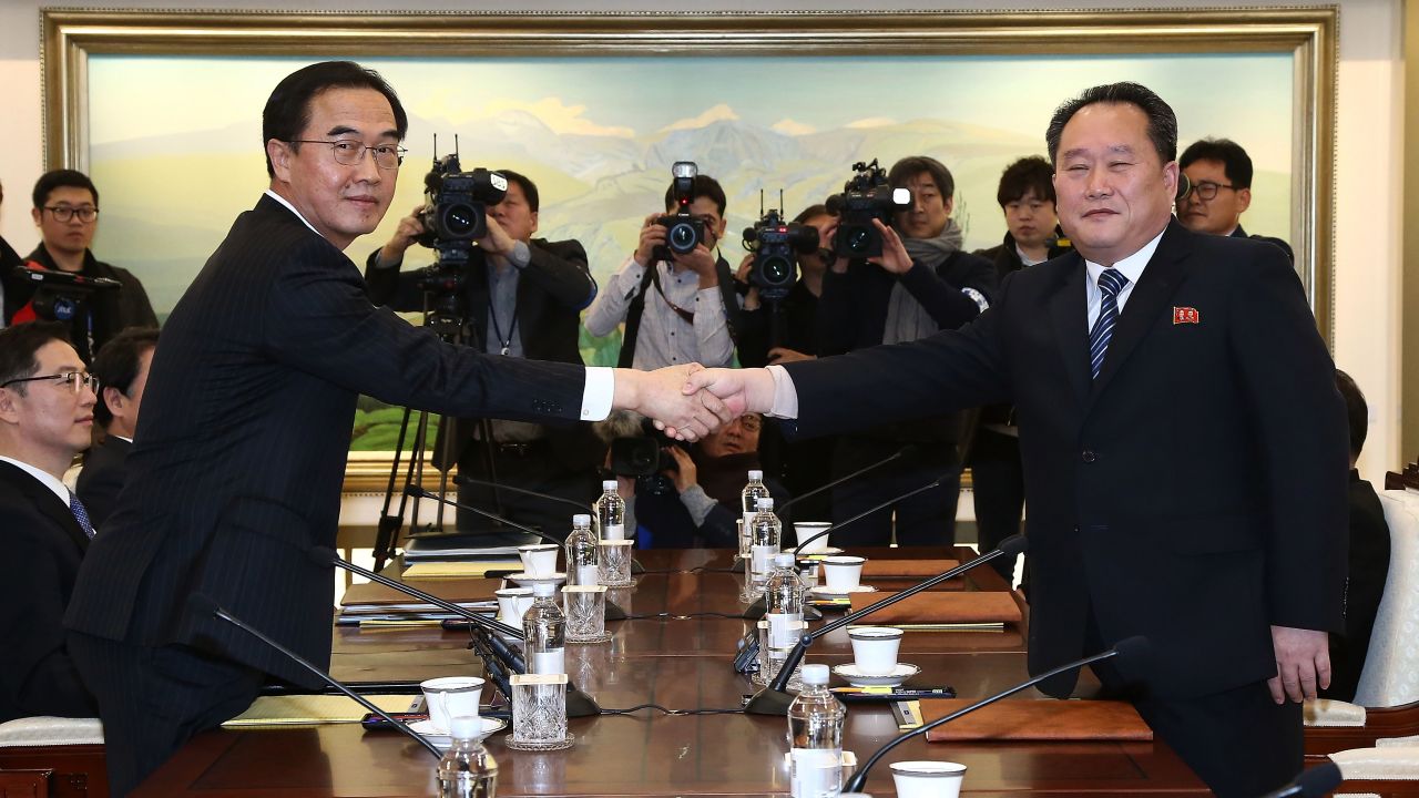 PANMUNJOM, SOUTH KOREA - JANUARY 09: South Korean Unification Minister Cho Myoung-gyon (L) shakes hands with the head of North Korean delegation Ri Son-Gwon (R) before their meeting at the Panmunjom in the Demilitarized Zone on January 9, 2018 in Panmunjom, South Korea. South and North Korea are scheduled to begin their first official face-to-face talks in two years on Tuesday, January 9, 2017. (Photo by Korea Pool/Getty Images)