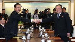 PANMUNJOM, SOUTH KOREA - JANUARY 09:  South Korean Unification Minister Cho Myoung-gyon (L) shakes hands with the head of North Korean delegation Ri Son-Gwon (R) before their meeting at the Panmunjom in the Demilitarized Zone on January 9, 2018 in Panmunjom, South Korea. South and North Korea are scheduled to begin their first official face-to-face talks in two years on Tuesday, January 9, 2017.  (Photo by Korea Pool/Getty Images)