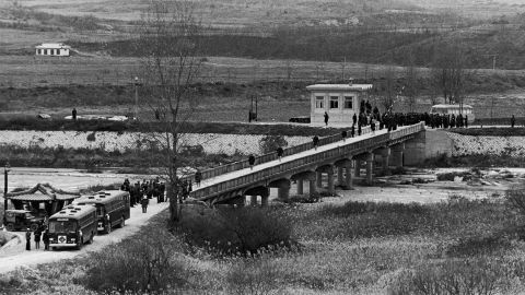 The crew of the USS Pueblo cross the Bridge of No Return between North and South Korea, after their release into US custody on December 23, 1968.