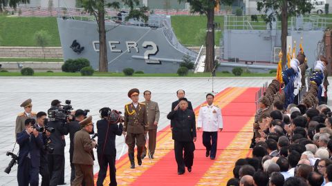 Noth Korean leader Kim Jong Un salutes as he walks in front of the USS Pueblo in Pyongyang on July 27, 2013.