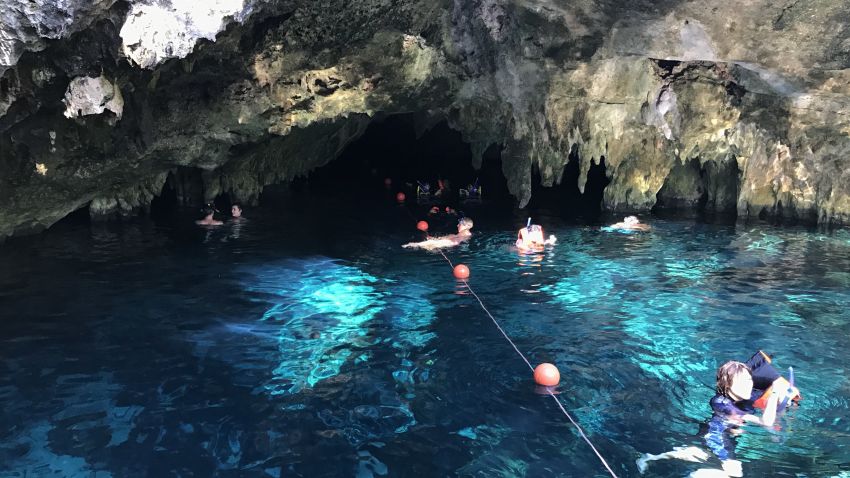 Tourists enjoy the water inside a Cenote in Tulum National Park, Quintana Roo state.