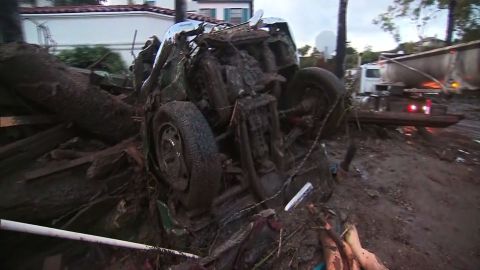 The remains of a car are jammed against muddy debris Tuesday in Montecito in Santa Barbara County.