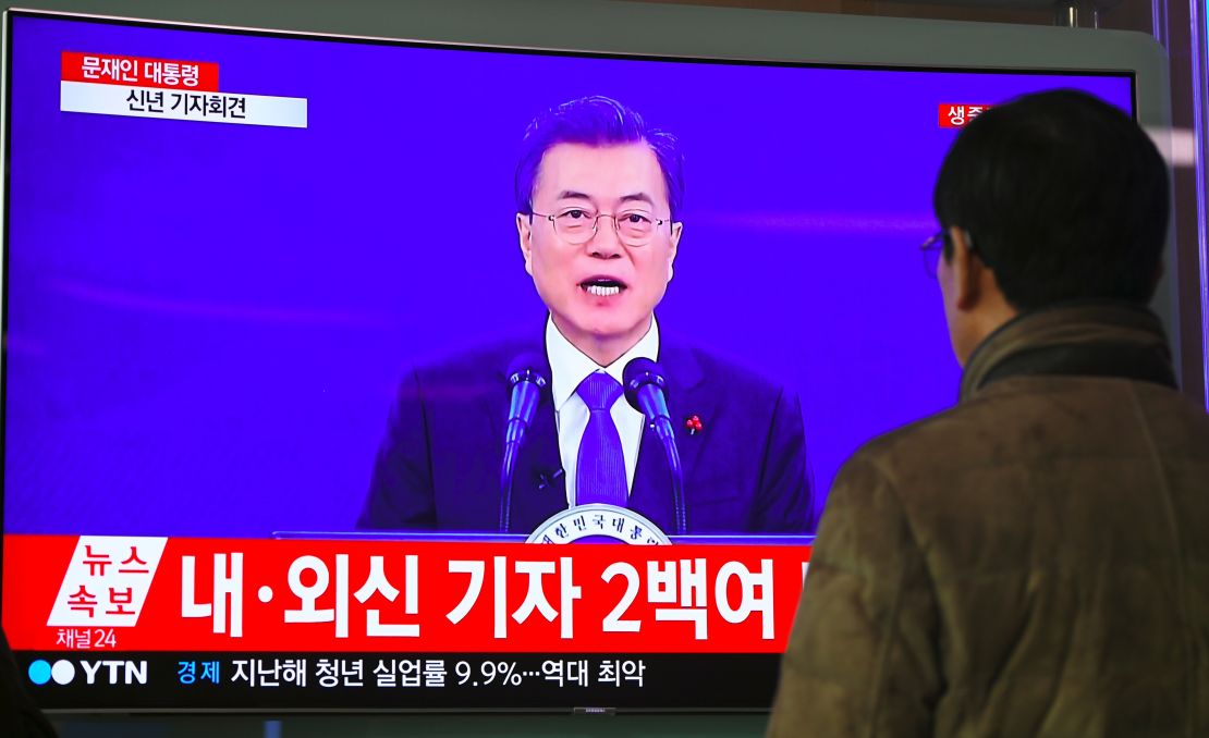 A man watches a television screen broadcasting live footage of South Korean President Moon Jae-In's New Year's speech, at a railway station in Seoul on January 10, 2018.