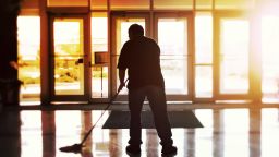 Janitor mopping an office floor, shallow focus, tilt shift image; Shutterstock ID 651210628; Purchase Order: -