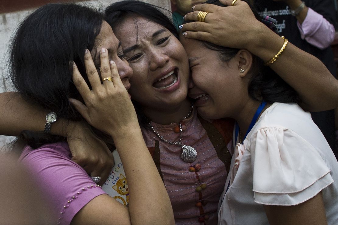 Family members react as Reuters journalist Kyaw Soe Oo leaves after a court appearance in Yangon on January 10, 2018.
