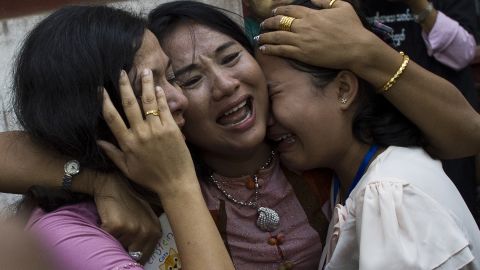 Family members react as Reuters journalist Kyaw Soe Oo leaves after a court appearance in Yangon on January 10, 2018.
