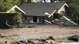 This photo provided by the Santa Barbara County Fire Department shows a home that has been buried in flood debris in Montecito, Calif., Tuesday, Jan. 9, 2018. Several homes were swept away before dawn Tuesday when mud and debris roared into neighborhoods in Montecito from hillsides stripped of vegetation during the Thomas wildfire.