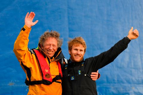 Gabart celebrates his record-breaking achievement with his routing manager Jean-Yves Bernot, who helped him navigate the high seas from dry land.
