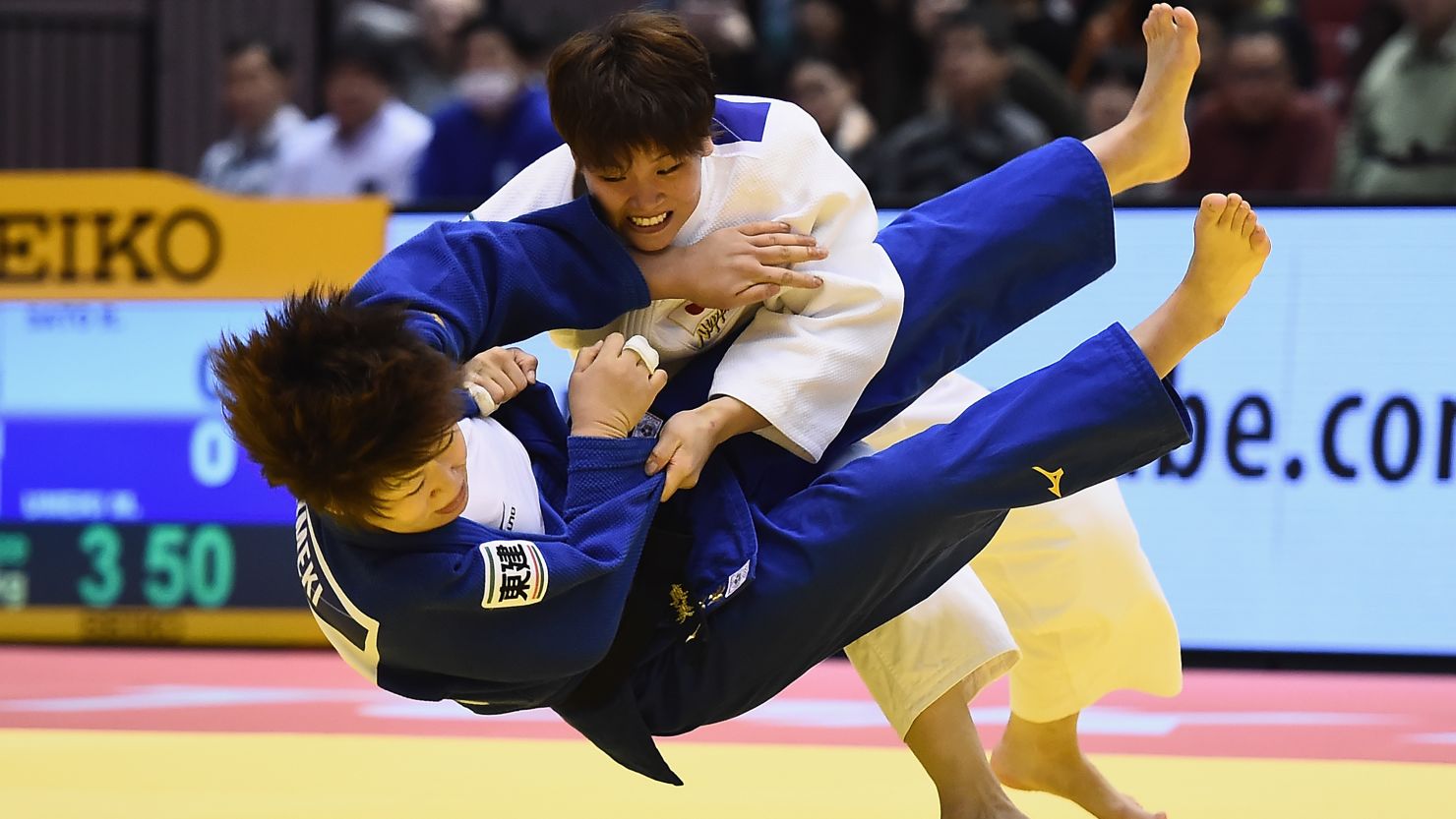 Judoka Ruika Sato (white) and Mami Umeki (blue) battle it out in December before the rule changes.