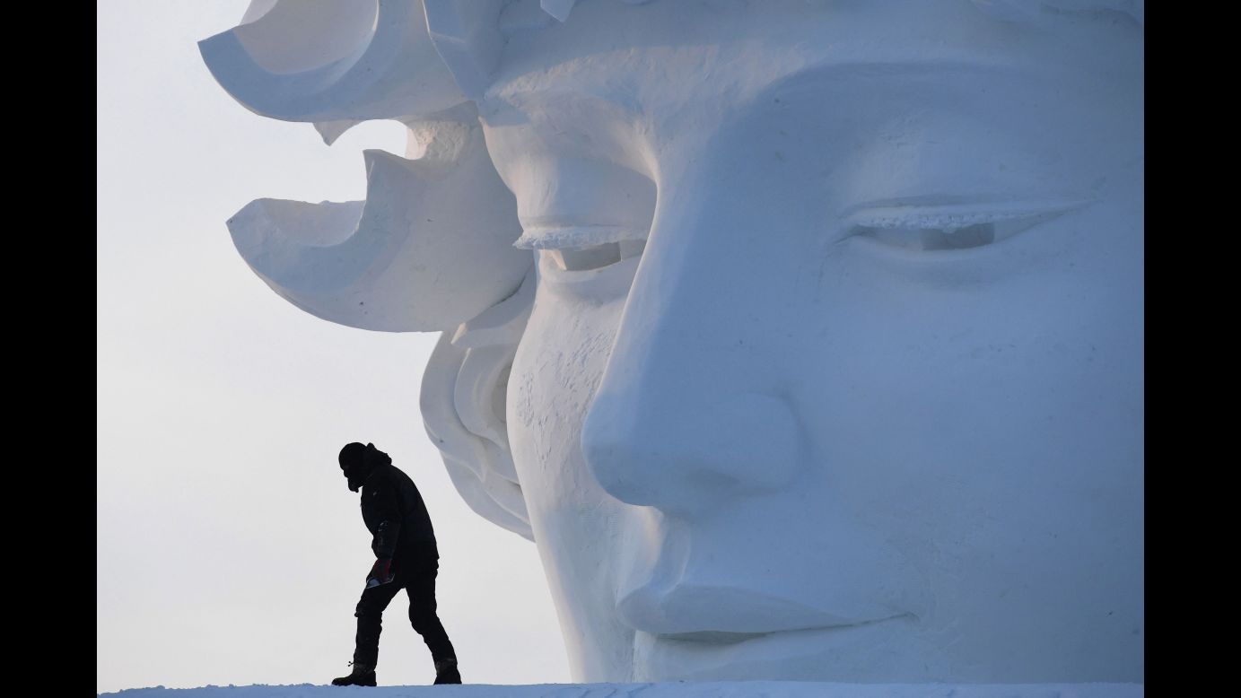 A worker walks past a snow sculpture before the opening of the Harbin International Ice and Snow Sculpture Festival on Friday, January 5. The festival in China's northeast Heilongjiang province attracts hundreds of thousands of visitors every year.