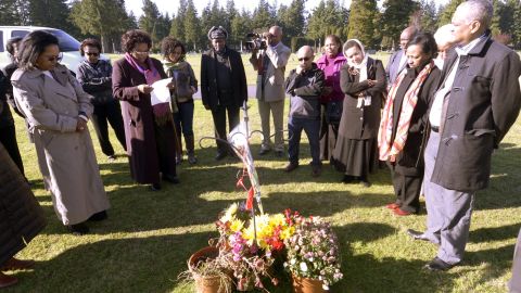 Members of Seattle's Ethiopian community gather around the grave of Hana Williams on October 29, 2013, a few hours after the sentencing of Larry and Carri Williams.