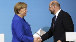 German Chancellor Angela Merkel, left, shakes hand with Social Democratic Party Chairman Martin Schulz during a joint statement after the exploratory talks between Merkel's Christian Democratic block and the Social Democrats on forming a new German government in Berlin, Germany, Friday, Jan. 12, 2018. (AP Photo/Markus Schreiber)