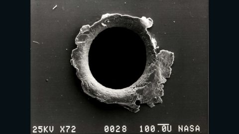 A close-up photograph showing damage sustained by the Solar Max experiment from a tiny piece of orbital debris.