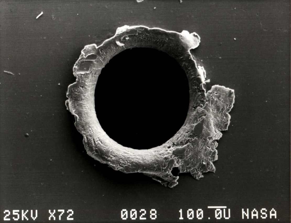 A close-up photograph showing damage sustained by the Solar Max experiment from a tiny piece of orbital debris.