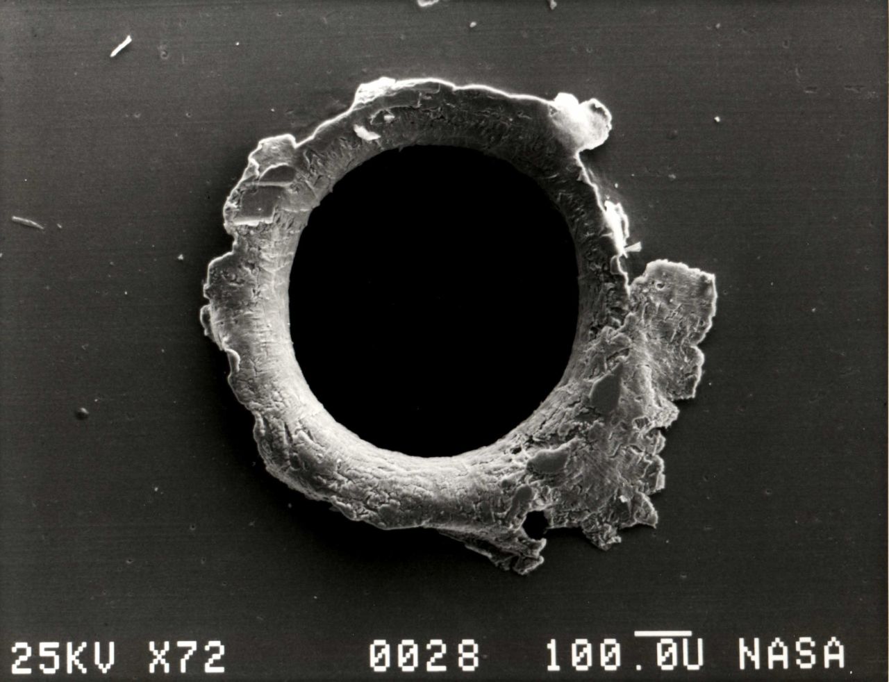A close-up photograph showing the damage sustained by the Solar MAX experiment from a tiny piece of space debris. Today the International Space Station has a number of debris protocols, from maneuvering out of a collision path to sheltering in a Soyuz capsule when the probability of a significant collision is high.   