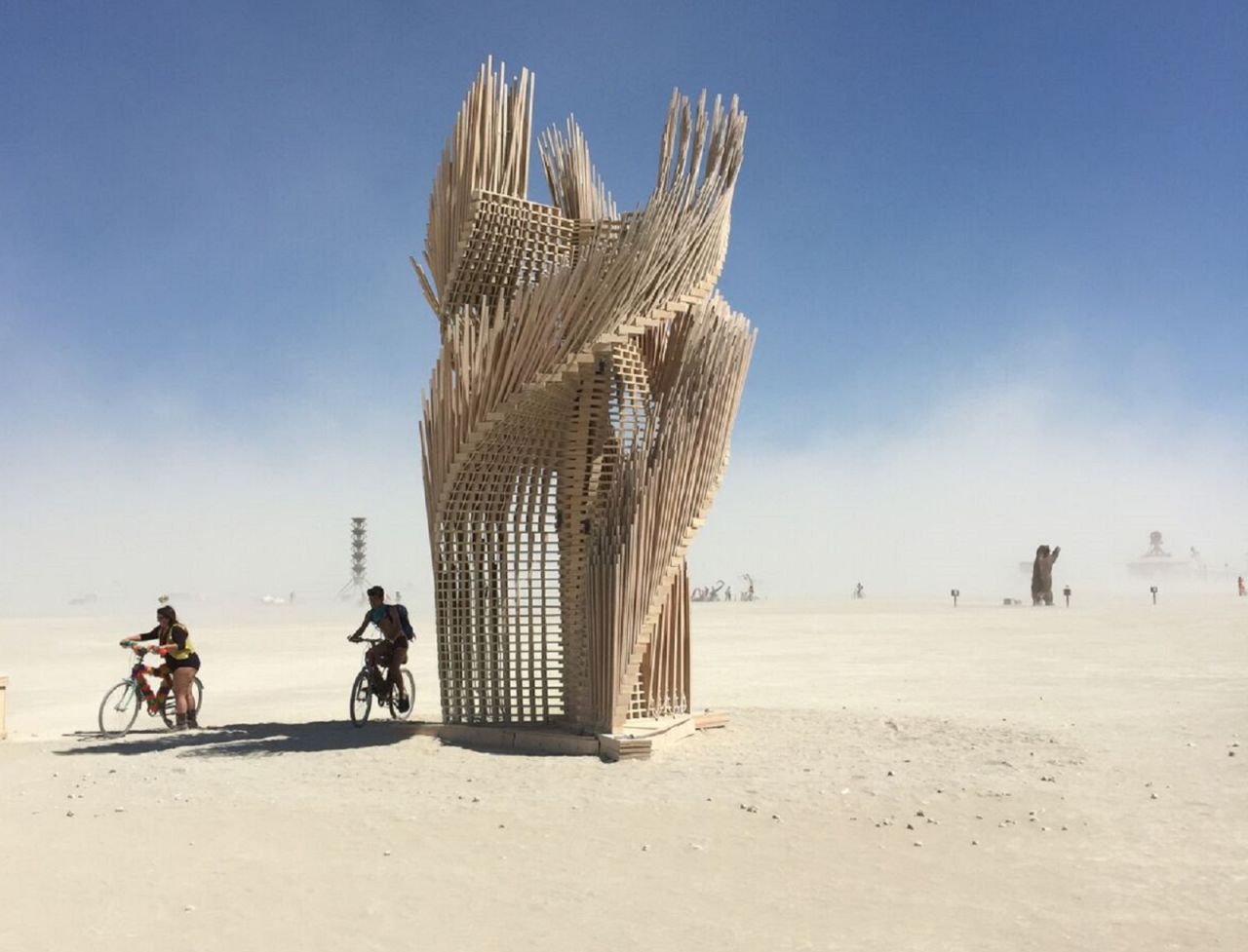 Tangential Dreams was a Mamou-Mani structure at Burning Man 2016. Digitally designed with algorithmic rules, the climbable tower was made from 1,000 thin wooden pieces held in pace by horizontal slats rotating along a central axis. This gave the impression of leaves on a tree gently moving in the wind. 