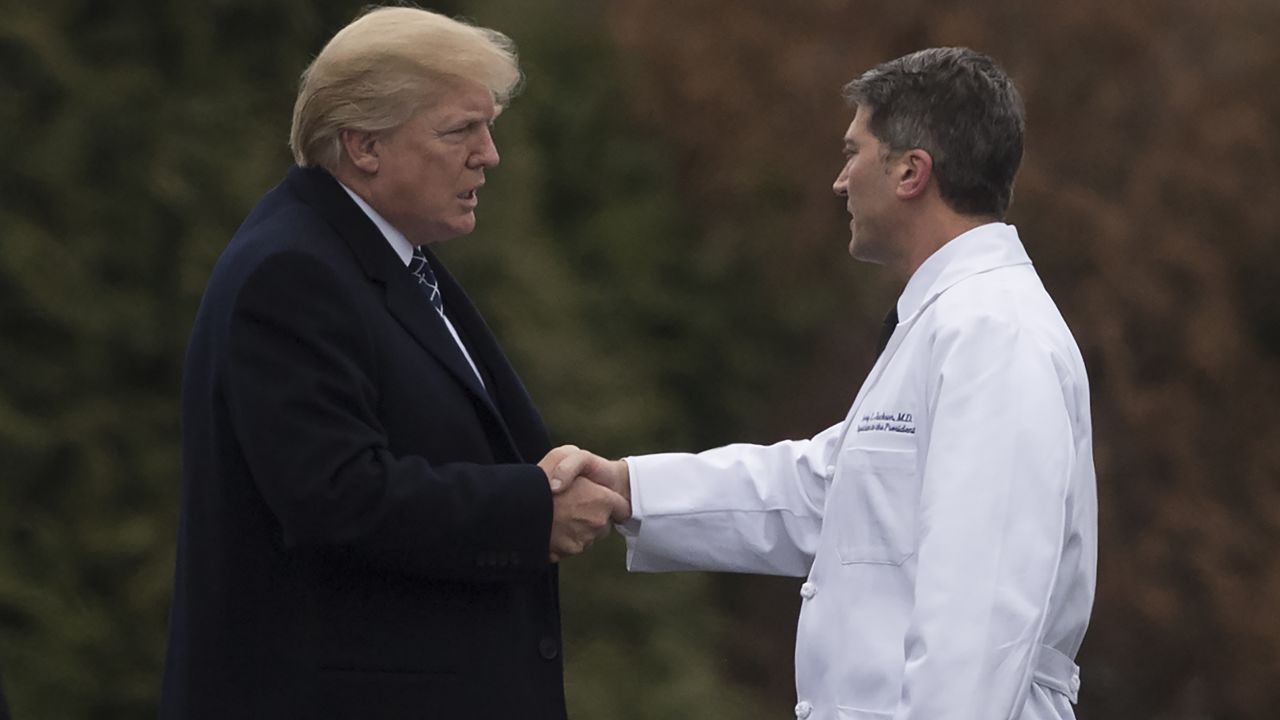 President Donald Trump shakes hands with White House Physician Rear Admiral Dr. Ronny Jackson, following his annual physical at Walter Reed National Military Medical Center in Bethesda, Maryland on January 12, 2018.