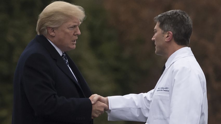 US President Donald Trump shakes hands with White House Physician Rear Admiral Dr. Ronny Jackson, following his annual physical at Walter Reed National Military Medical Center in Bethesda, Maryland, January 12, 2018. / AFP PHOTO / SAUL LOEB        (Photo credit should read SAUL LOEB/AFP/Getty Images)