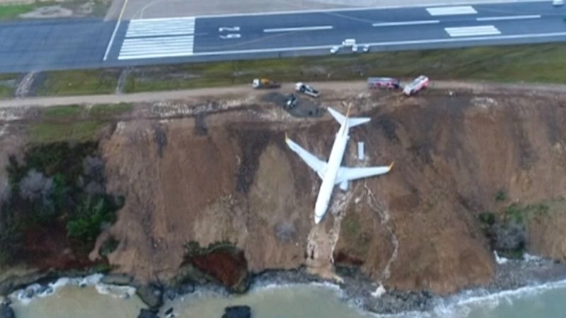 Plane Skids Off Runway, Gets Stuck On Cliff | CNN