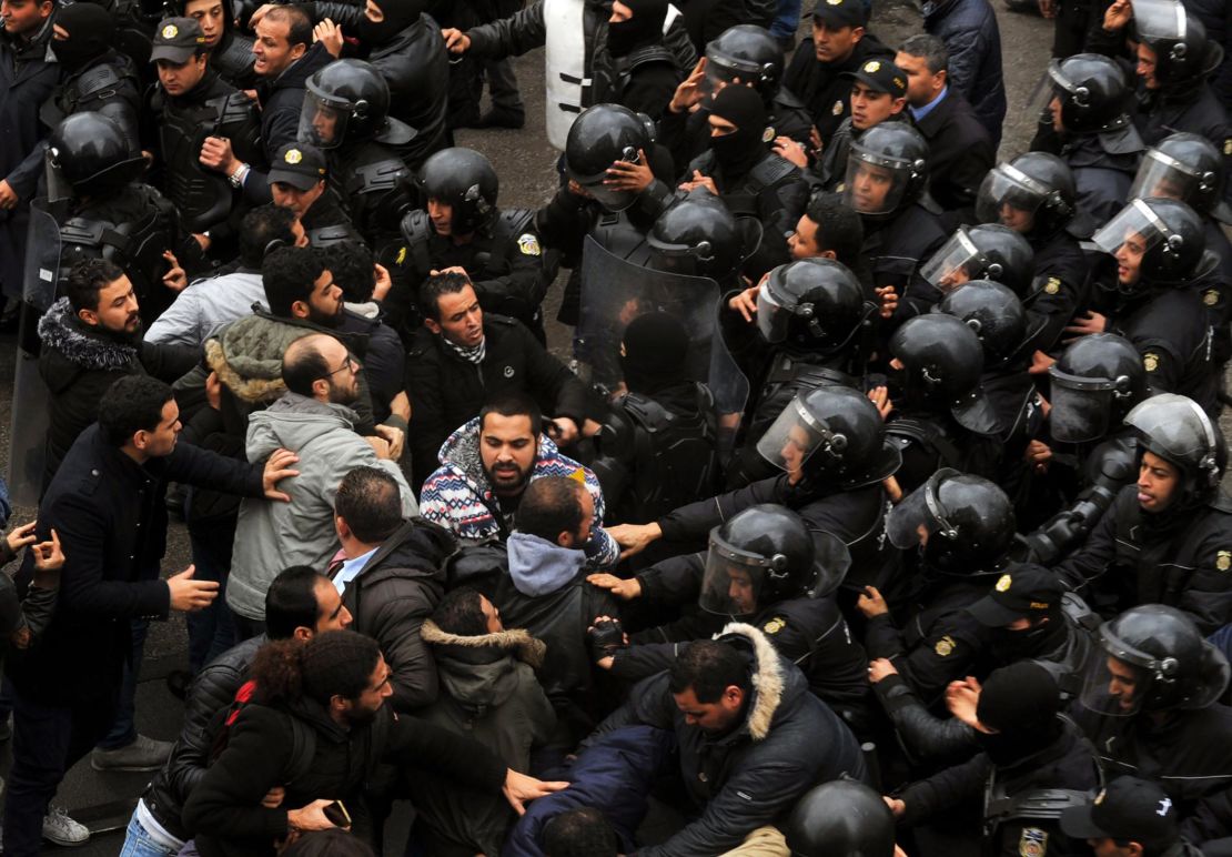 Protesters and security forces face off outside government offices on Friday January 12.