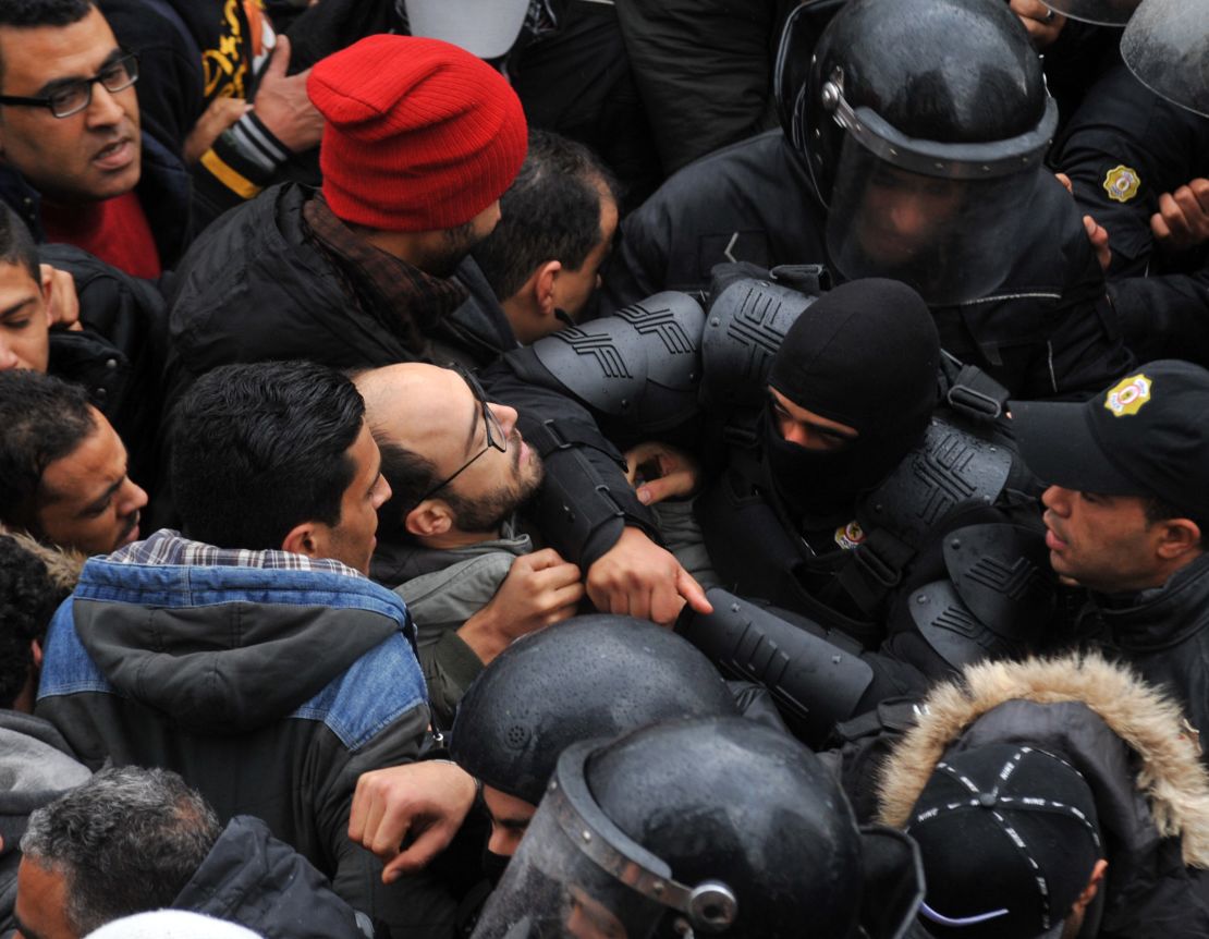 Protesters confront security forces in the capital city of Tunis on Friday, January 12.