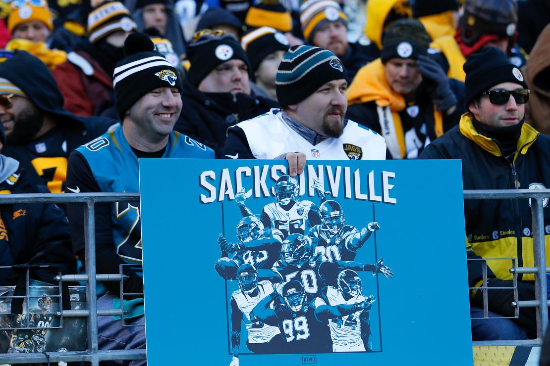 A Jaguars fan holds a sign reading 'Sacksonville' at Heinz Field on Sunday.
