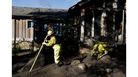 A Cal Fire search and rescue crew at a storm-damaged home in Montecito.