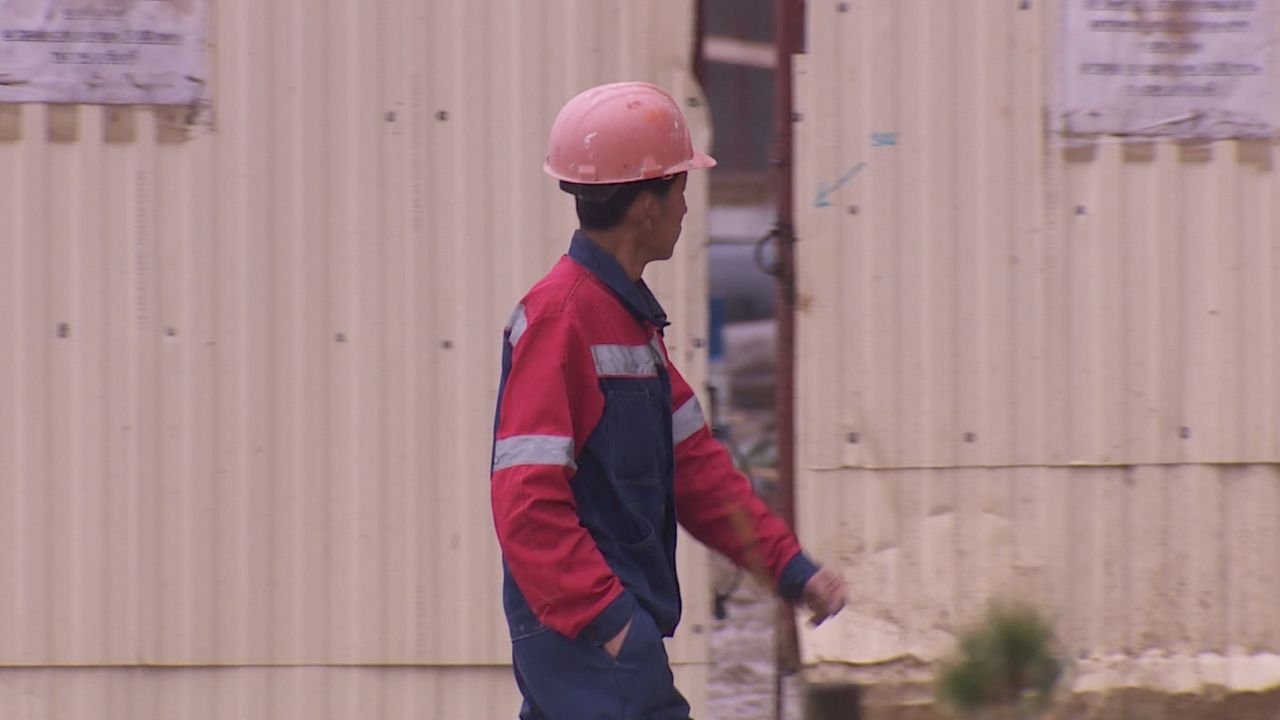 A North Korean worker walks through the building site.